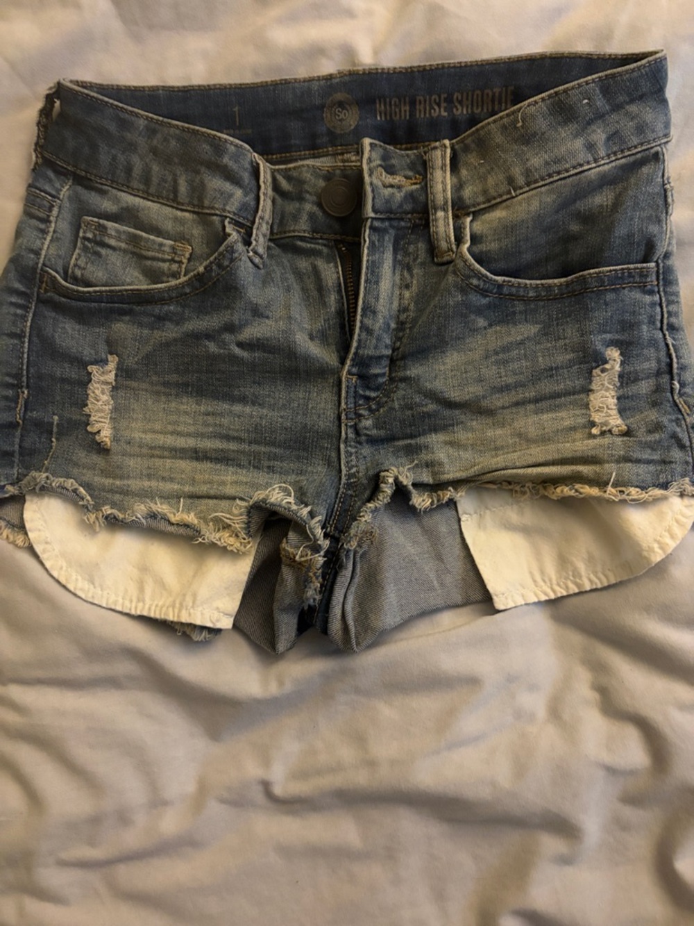 SO High-Rise Distressed Jean Shorties in Light Blue